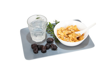 Corn flakes served with dates and cold water during fasting month of Ramadhan