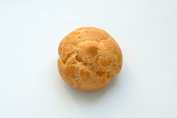 Profiteroles on a white background top view. A small culinary product of French cuisine with custard dough with a filling inside. A small round brown quiche.