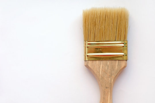 Paint brush with natural pile. Paint tools on a white background top view. Paint brush with wooden handle.