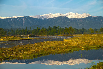 reflection of snow mountains in water in Himalayan ranges in Kashmir India