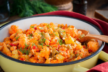 Vegetable stew with cauliflower in an enamel pan, selective focus