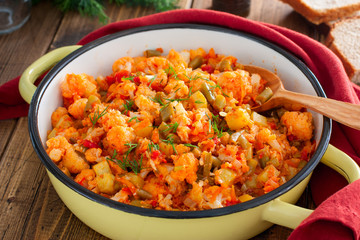 Vegetable stew with cauliflower in an enamel pan, selective focus