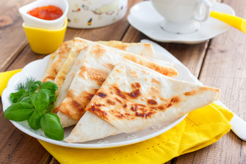 Envelopes in the form of a triangle of pita bread stuffed with cheese and herbs, selective focus