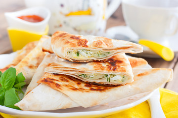 Envelopes in the form of a triangle of pita bread stuffed with cheese and herbs, selective focus