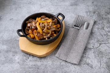 potatoes with mushrooms in a hot pan