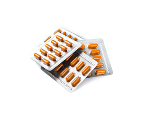 Orange pill capsules in blister packs isolated on white background with clipping path