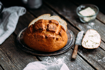 Wheat flour bread on the table. Sandwich with butter