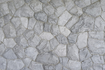 Decorative slate stone wall surface for texture background. Seamless texture, Old castle stone wall texture background.Stone wall as a background or texture. Part of a stone wall.