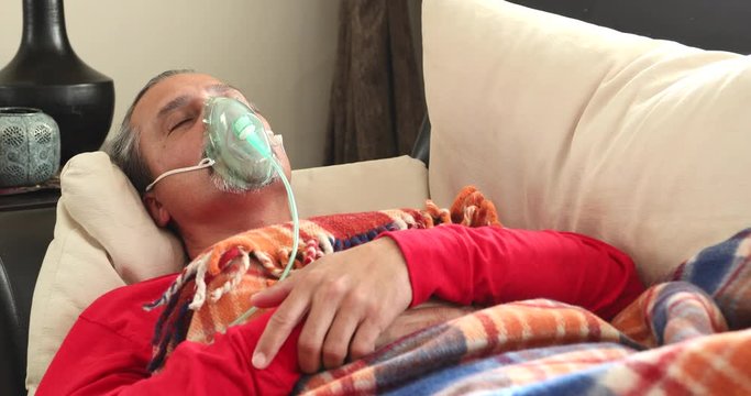 Home Quarantine or İsolation Concept  Epidemic Infection Covid-19  Coronavirus Patient  With Nebulizer Mask Resting At Home