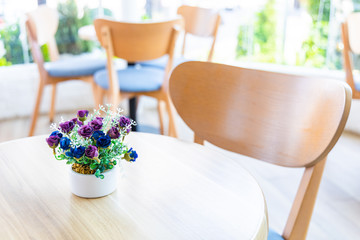 Wooden chairs  with flower pot in cafe