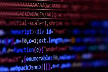 Close-up of minified javascript file. Computer programming source code for HTML website development.