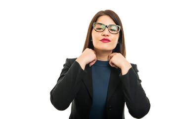 Portrait of business girl wearing glasses arranging shirt