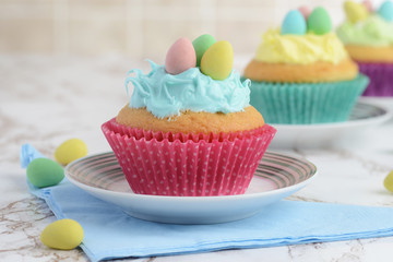 closeup easter cupcake with mini colorful eggs