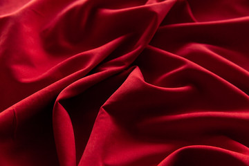 Beautiful fabric of one color is folded on a table in daylight