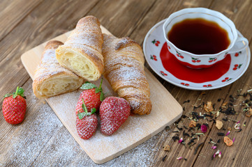 Appetizing homemade croissants with a cup of tea