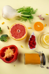 Immune boosting health food and medical pills over yellow background
