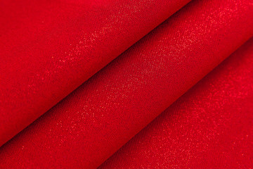 Beautiful fabric of one color is folded on a table in daylight