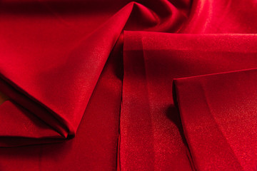 Beautiful fabric of one color is folded on a table in daylight
