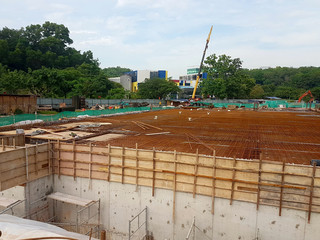 Building floor slab under construction. Construction workers fabricating the timber formwork and...