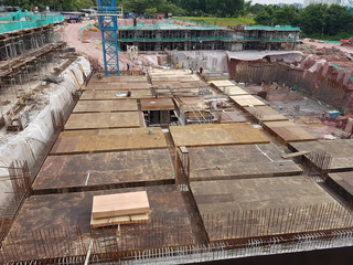 Building floor slab under construction. Construction workers fabricating the timber formwork and installing the steel reinforcement bar.
