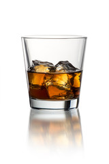 Glass with whiskey on the white background with ice