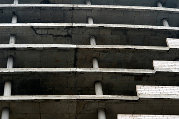 Floors of a large gray concrete building without external walls. Textured background