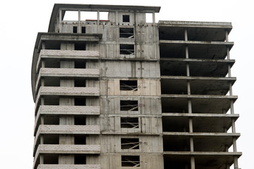 Concrete gray high-rise building partially without external walls. Background