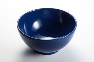 Empty blue bowl on white background