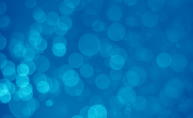 abstract blue bokeh glitter sparkle background.