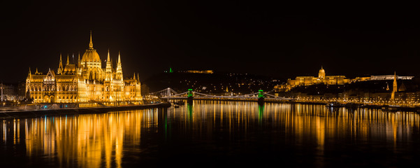 Fototapeta na wymiar Panorama of Budapest with Hungarian Parliament and Buda Castle. Chain Bridge with green lights on St. Patrick's day in Budapest at night.