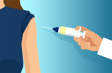 doctor with syringe injecting vaccine to a patient shoulder