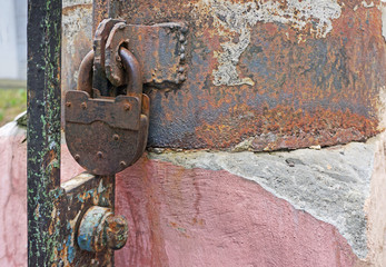 an old rusty lock on the grating