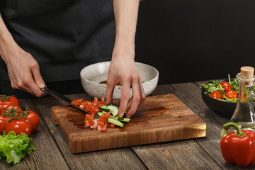 Woman cooking fresh vegetable salad. Female hands. Diet concept for healthy lifestyle with copyspace.