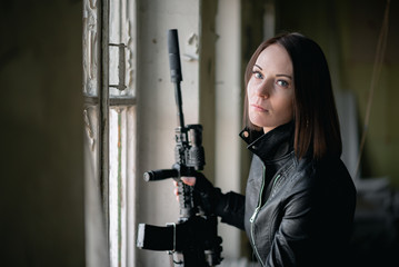 Concept of special agent girl with airsoft rifle.