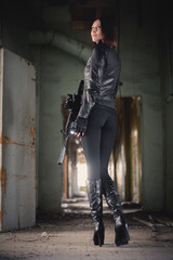 Fototapeta na wymiar Concept of special agent girl with airsoft rifle.
