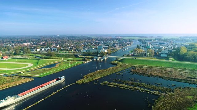 Two Big Cargo Boats Approaching a Bridge, Tracking Shot - Friesland, The Netherlands / Holland 4K Drone Footage