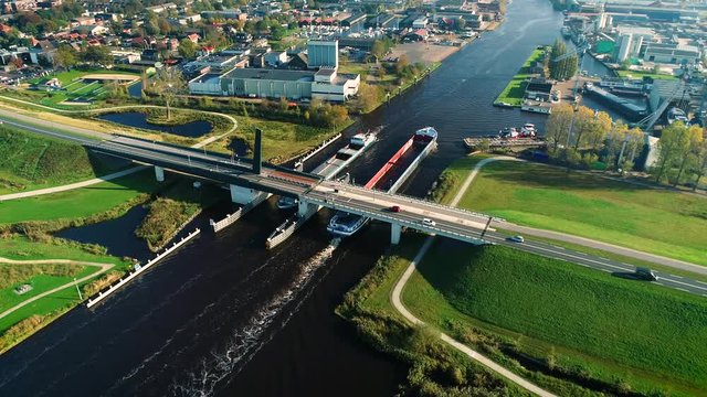 Two Big Cargo Boats Passing Each Other Beneath a Bridge, Rotating Shot - Friesland, The Netherlands / Holland 4K Drone Footage