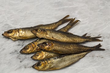 Close up view of smoked fish isolated on gray background. Healthy food concept.