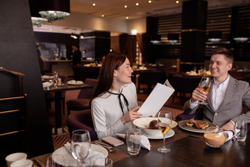 young caucasian married couple have conversation in restaurant. man and woman came to celebrate their anniversary, happy couple in luxury restaurant. romantic place for rendezvous