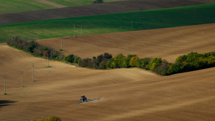 Obraz premium Work with an agricultural tractor in Moravian fields.