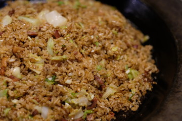 Close up chinese fried rice in pot. Blur background