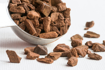 Cinnamon Chips Spilled from a Teaspoon