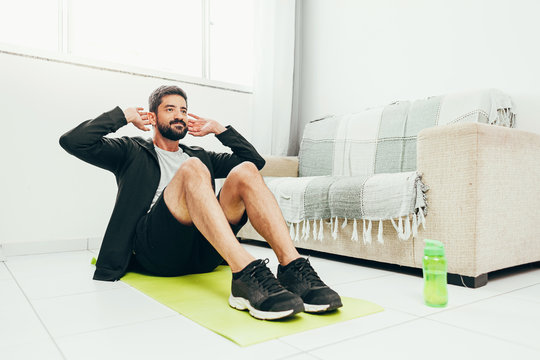 Man Working Out At Home Doing Sit Ups