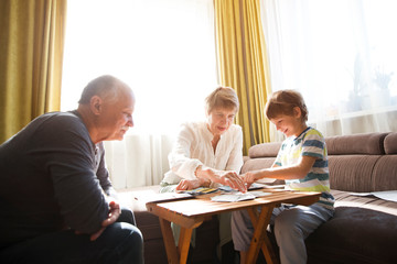 Grandparents playing board game with grandson