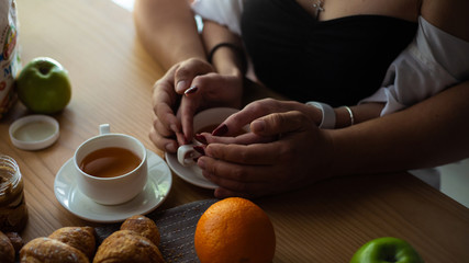 Tea in hand. The lovers are together. Selective focus.