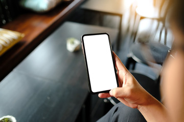 Close up of man using cell phone,sending massages on the coffee shop with black screen,texting,video calls.