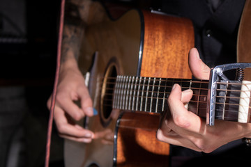 man playing guitar at wooden background, acoustic