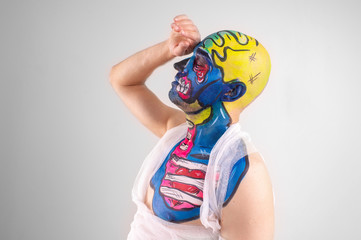 Portrait of a quaint male with painted head and shoulder isolated on white background