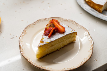 Homemade Victoria Sponge Cake Slice with Strawberry, Dried  Lemon Slices and Powdered Sugar.