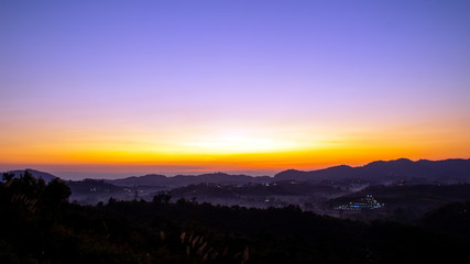 Fototapeta na wymiar golden light before sunrise on foggy mountain landscape